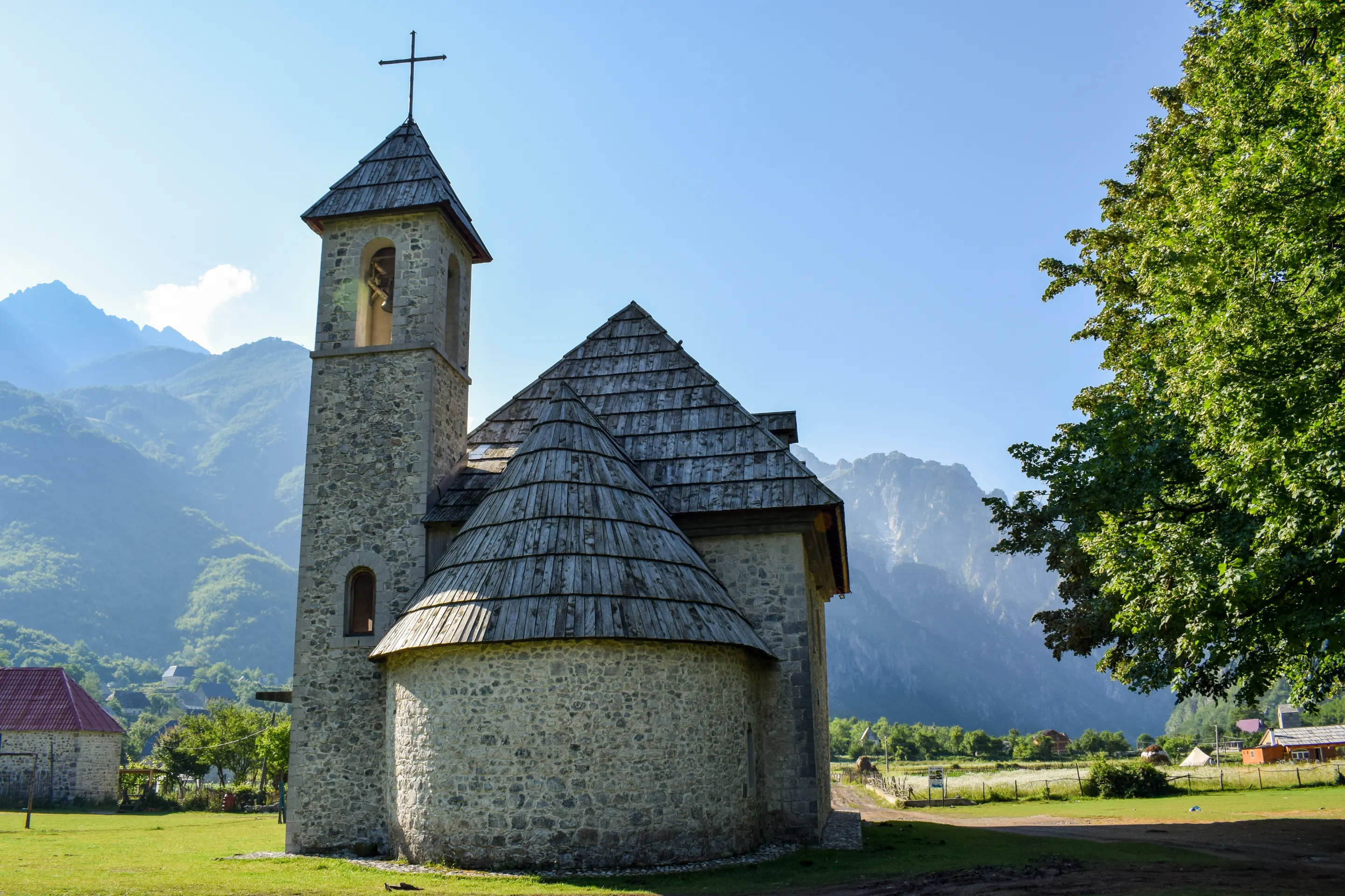 The shingle-roofed church of Theth against the Albanian Alps